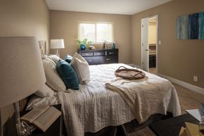 Omaha apartment for rent - a bedroom with a bed and a dresser and a window