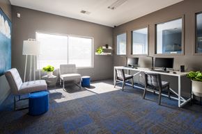 Omaha apartment for rent - a rendering of an office space with a desk and chairs and a computer