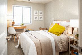 Omaha apartment for rent - a bedroom with a bed and a desk and a window