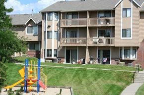 Omaha apartment for rent - an apartment building with a playground in front of it