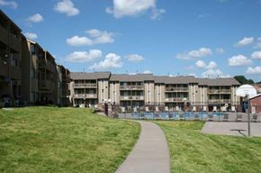 Omaha apartment for rent - an apartment building with a walkway next to a pool