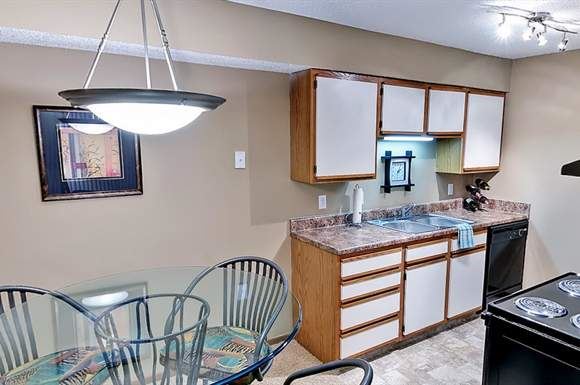 Omaha apartment for rent - a kitchen and dining room with a glass table and chairs