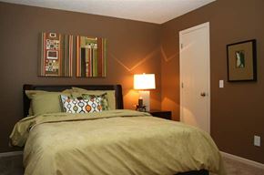 Omaha apartment for rent - a bedroom with a bed and a lamp