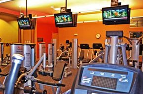 Omaha apartment for rent - A gym with a variety of equipment including treadmills, weights, and exercise machines.