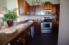 Omaha apartment for rent - A kitchen with wooden cabinets and a stainless steel oven.
