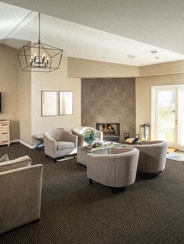 Omaha apartment for rent - a living room with couches and chairs and a fireplace