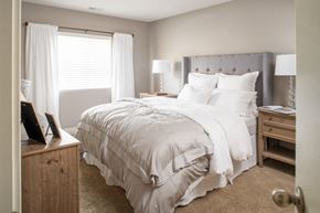 Omaha apartment for rent - a bedroom with a bed and a dresser and a window