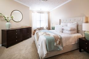 Omaha apartment for rent - a bedroom with a bed and two dressers and a window