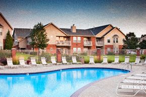 Omaha apartment for rent - an image of a swimming pool in front of a house