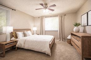 Omaha apartment for rent - a bedroom with a bed and a ceiling fan