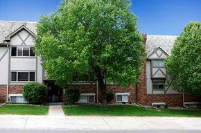 Omaha apartment for rent - a tree in front of an apartment building