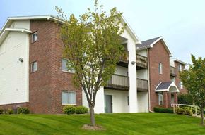 Omaha apartment for rent - a tree in front of an apartment building