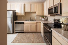 Omaha apartment for rent - A kitchen with wooden cabinets and a black oven.