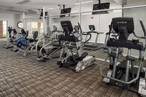 Omaha apartment for rent - A gym with a variety of exercise equipment including treadmills, stationary bikes, and weight machines.