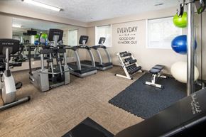 Omaha apartment for rent - a gym with cardio equipment and weights in a resident fitness center