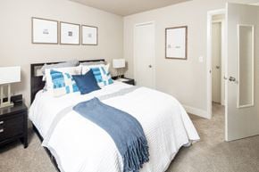 Omaha apartment for rent - a bedroom with a large bed and a closet