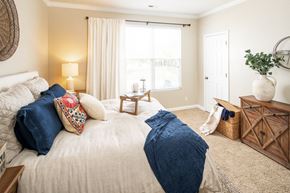 Omaha apartment for rent - a bedroom with a bed and a large window