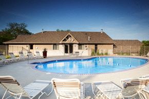 Bellevue apartment for rent - A pool surrounded by chairs in front of a house.