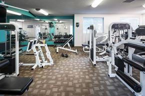 Lincoln apartment for rent - a gym with cardio equipment and weights on a wooden floor