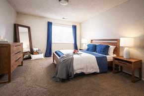 Lincoln apartment for rent - a bedroom with a bed and a dresser and a window