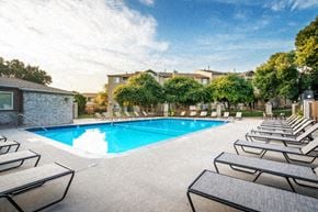 Lincoln apartment for rent - a swimming pool with rows of lounge chairs around it