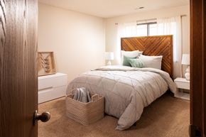 Lincoln apartment for rent - a bedroom with a bed and a basket on the floor