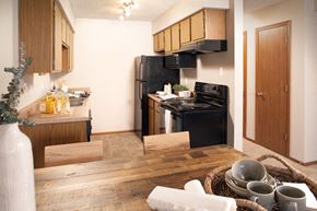 Lincoln apartment for rent - a kitchen with black appliances and a wooden table