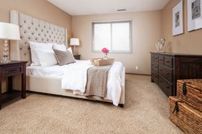 Sioux City apartment for rent - a bedroom with a bed and a dresser and a window