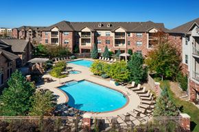 West Des Moines apartment for rent - an aerial view of a swimming pool with apartments in the background