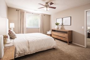 Windsor Heights apartment for rent - A bedroom with a bed, nightstand, and a ceiling fan.