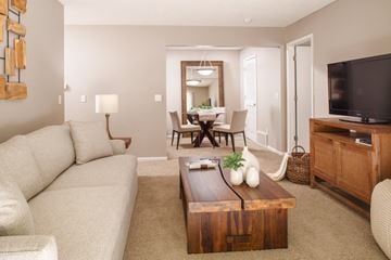 Windsor Heights apartment for rent - A living room with a white couch and a wooden coffee table.