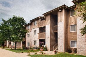 Des Moines apartment for rent - a row of brick apartment buildings with balconies and a tree