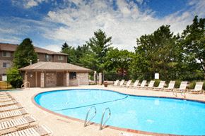 Des Moines apartment for rent - a swimming pool with chairs in front of a house