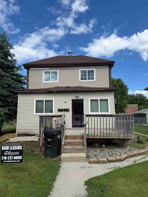 Fargo apartment for rent - A house with a leasing sign in front.