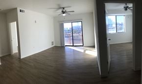 Tucson apartment for rent - an empty living room with wooden floors and a ceiling fan