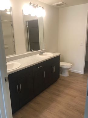 Tucson apartment for rent - a bathroom with two sinks and a toilet and a mirror