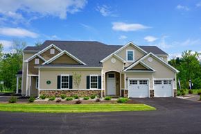 Albany apartment for rent - a house with two garage doors and a lawn