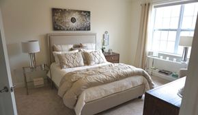 Albany apartment for rent - A bedroom with a large bed and a painting on the wall.