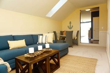 Troy apartment for rent - a living room with a blue couch and a wooden table