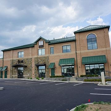 Latham apartment for rent - A brick building with a green awning and the word "Pinetop" on the front.