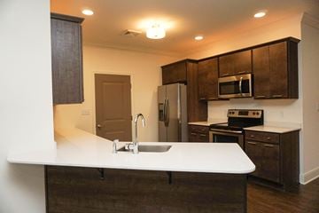 Latham apartment for rent - A kitchen with brown cabinets and white countertop.