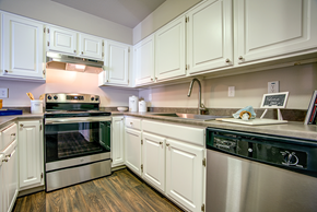 Martinez apartment for rent - A kitchen with white cabinets and stainless steel appliances.