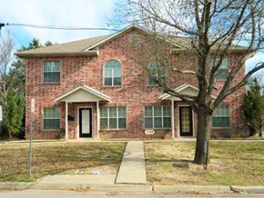 Commerce apartment for rent - a brick house with a tree in front of it