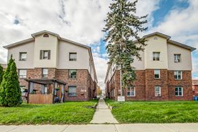 Oshawa apartment for rent - A row of houses with a sidewalk in between.