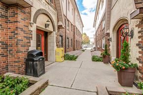 Oshawa apartment for rent - A narrow alley with brick buildings and a red door.