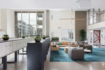 San Jose apartment for rent - A modern living room with a long table and chairs.