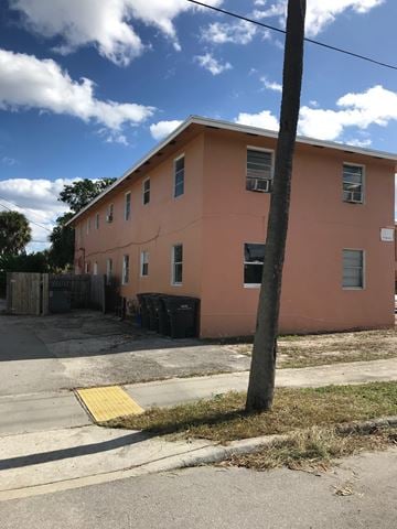 West Palm Beach apartment for rent - A pink building with a tree in front of it.