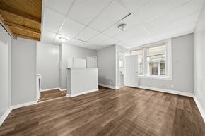 Philadelphia apartment for rent - an empty living room with wood floors and a window