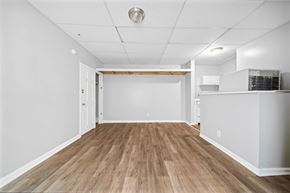 Philadelphia apartment for rent - the living room and kitchen of a new home with white walls and wood floors