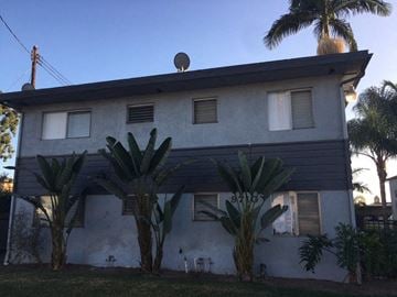 Bellflower apartment for rent - a white and black house with palm trees
